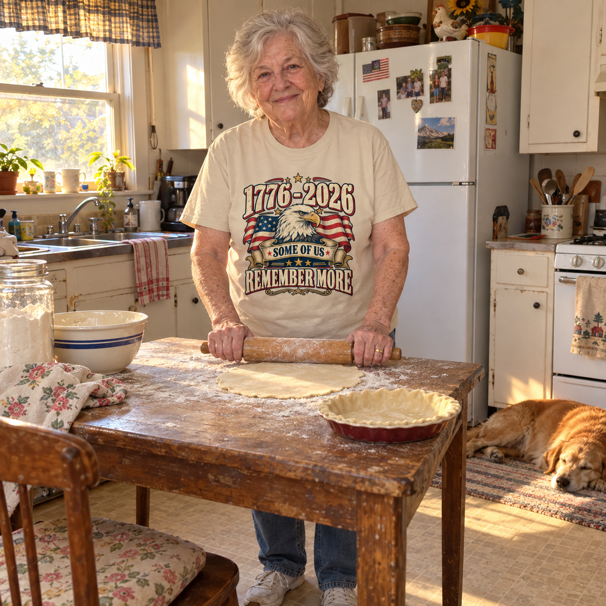 Senior woman rolling dough wearing cream vintage t-shirt printed 1776-2026 Some Of Us Remember More