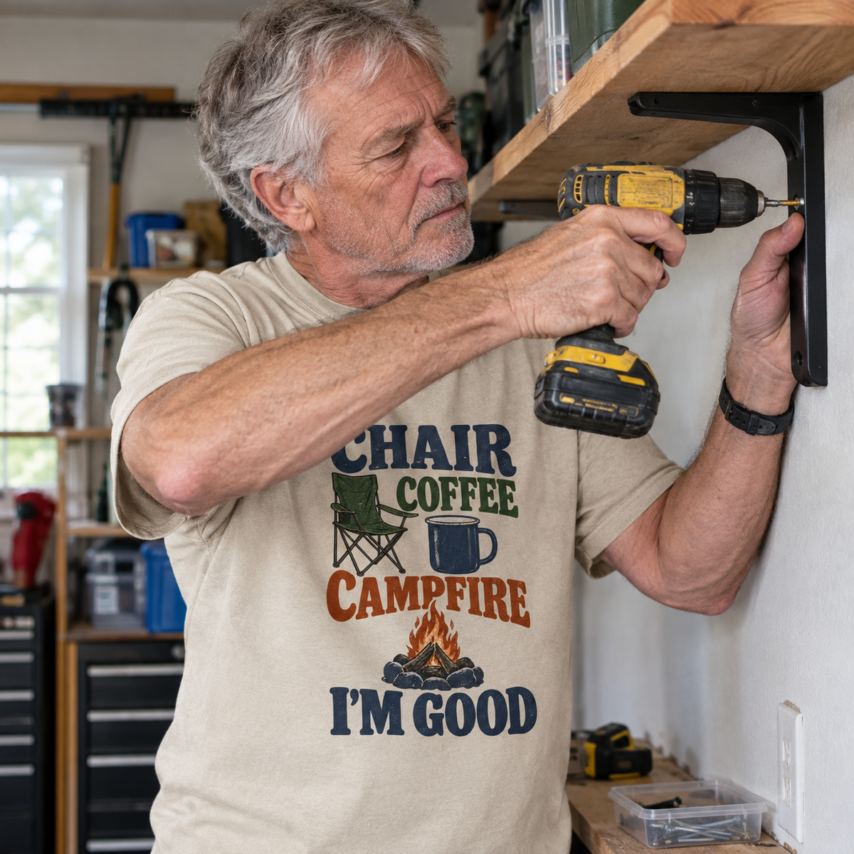 Senior man wearing beige vintage t-shirt with Chair Coffee Campfire I'm Good printed design, lifestyle view