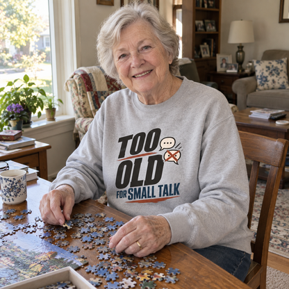 Senior woman doing a puzzle wears gray vintage sweatshirt printed Too Old For Small Talk