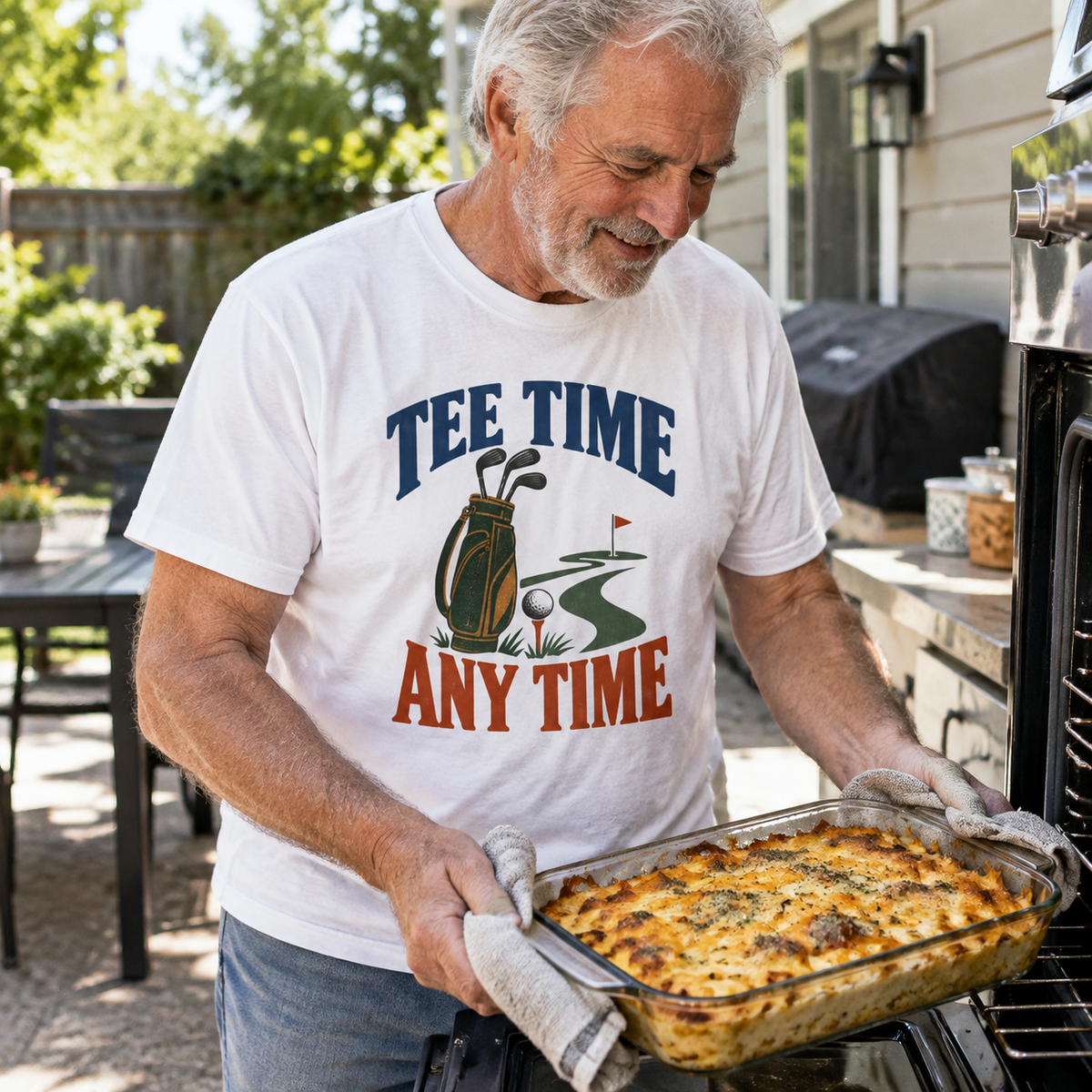 White vintage t-shirt features printed “Tee Time Any Time,” worn by senior man outdoors