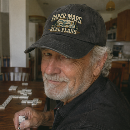 Senior man wearing a black vintage washed cap printed with Paper Maps. Real Plans.