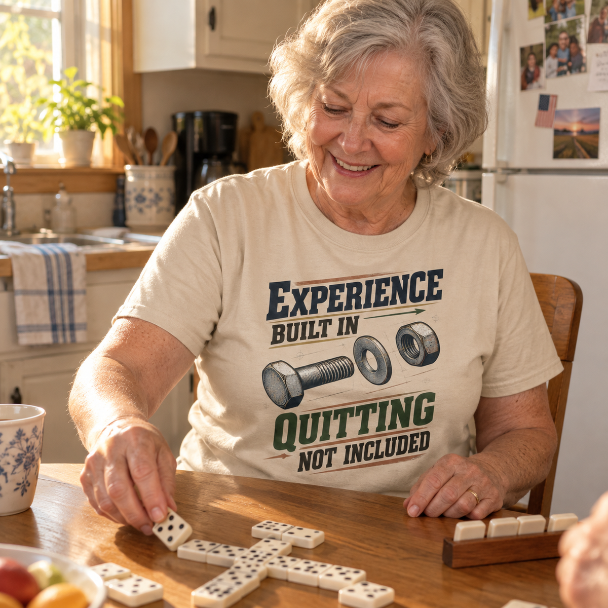 Senior woman playing dominoes in a beige vintage t-shirt printed Quitting Not Included
