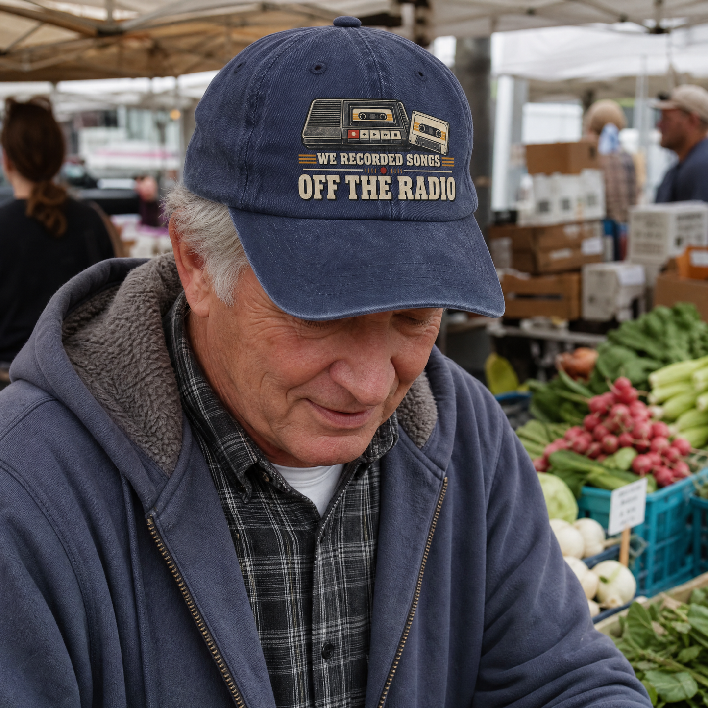 Washed cap with printed “We Recorded Songs Off The Radio,” worn by senior man in market