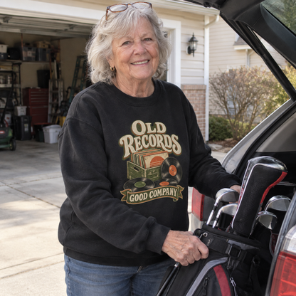 Senior woman wearing black vintage sweatshirt with printed Old Records Good Company design beside car