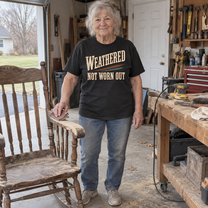 Senior woman wearing black vintage t-shirt with Weathered Not Worn Out print in workshop