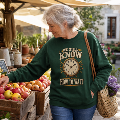 Senior woman wearing green vintage sweatshirt with printed “We Still Know How To Wait”