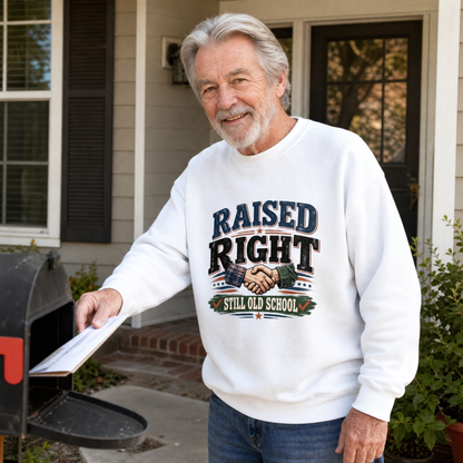 White vintage sweatshirt with “Raised Right Still Old School” print worn by senior man outdoors.