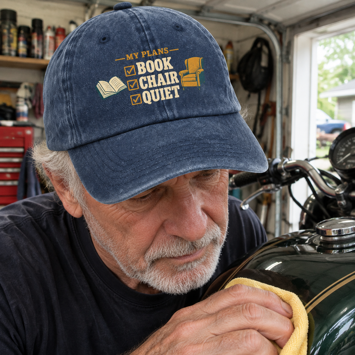 Blue vintage washed cap with printed “My Plans Book Chair Quiet” worn by senior man