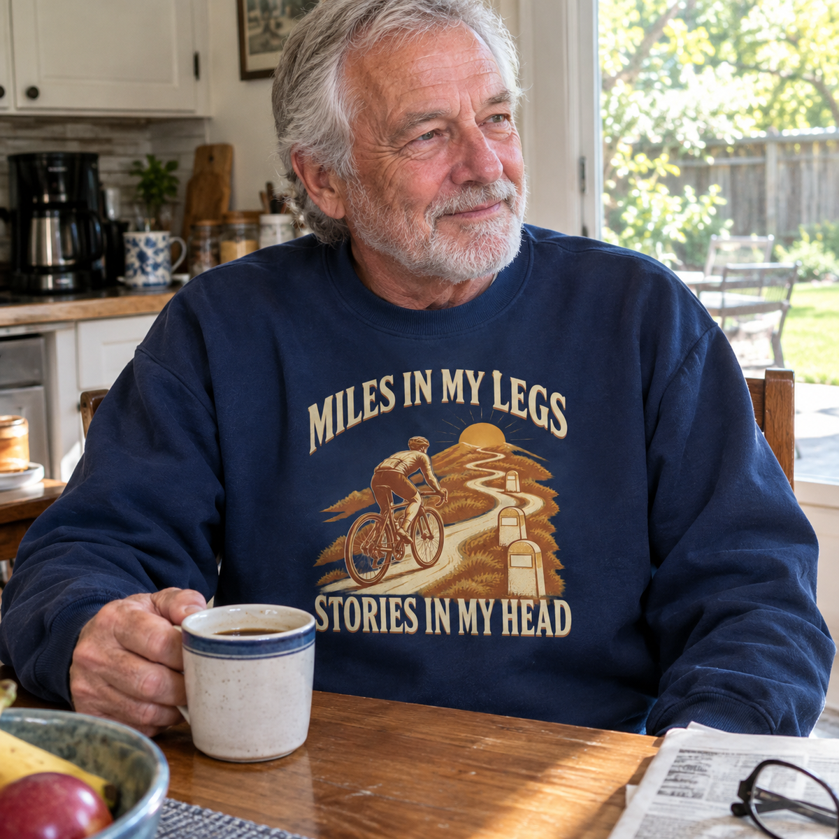 Senior man wearing navy vintage sweatshirt with printed Miles In My Legs design indoors