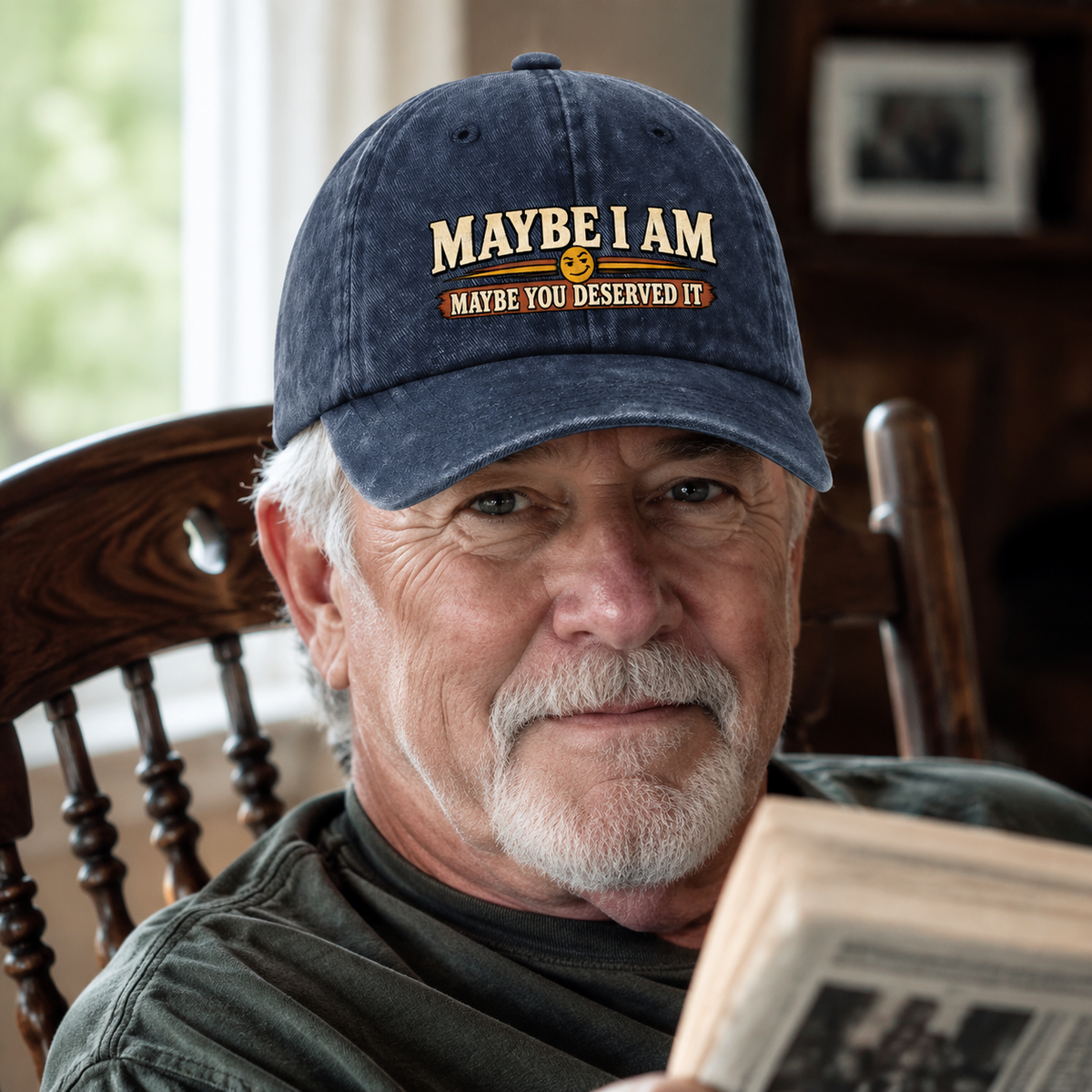 Navy vintage washed cap with printed slogan, worn by a senior man indoors.
