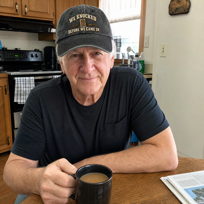 Senior man wearing black vintage washed cap with printed We Knocked Before We Came In