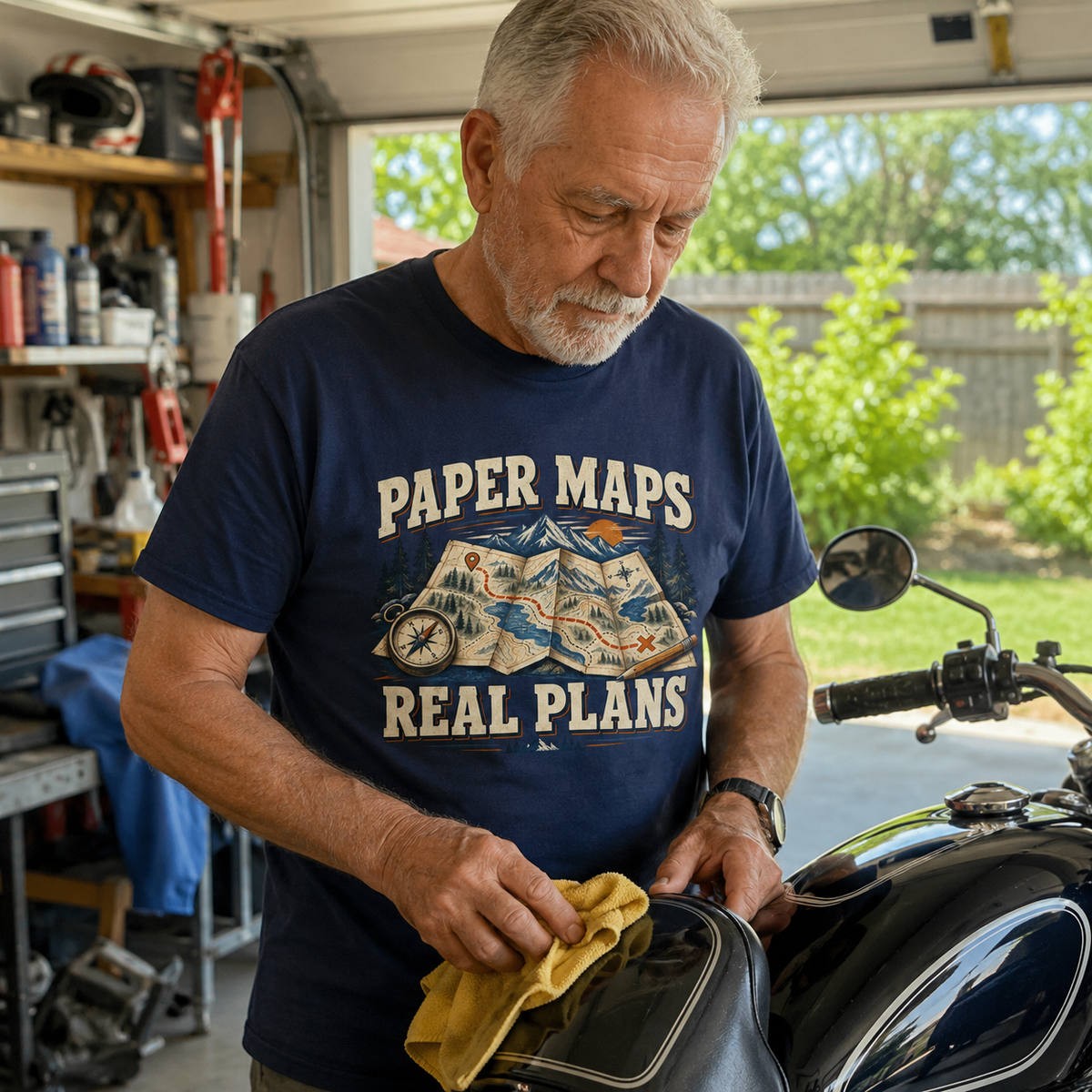 Navy vintage t-shirt with printed Paper Maps Real Plans design, worn by senior man.