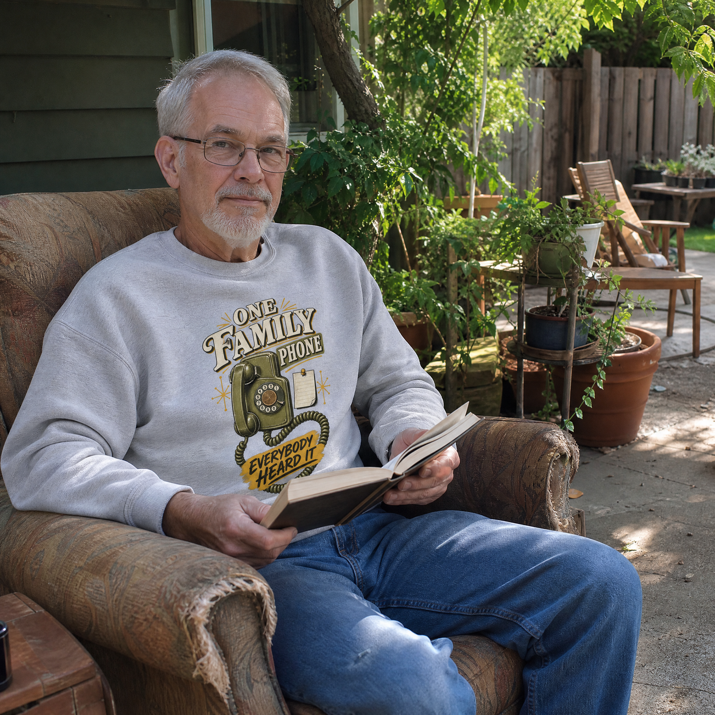 Vintage sweatshirt with printed “One Family Phone. Everybody Heard It,” worn by senior man outdoors.