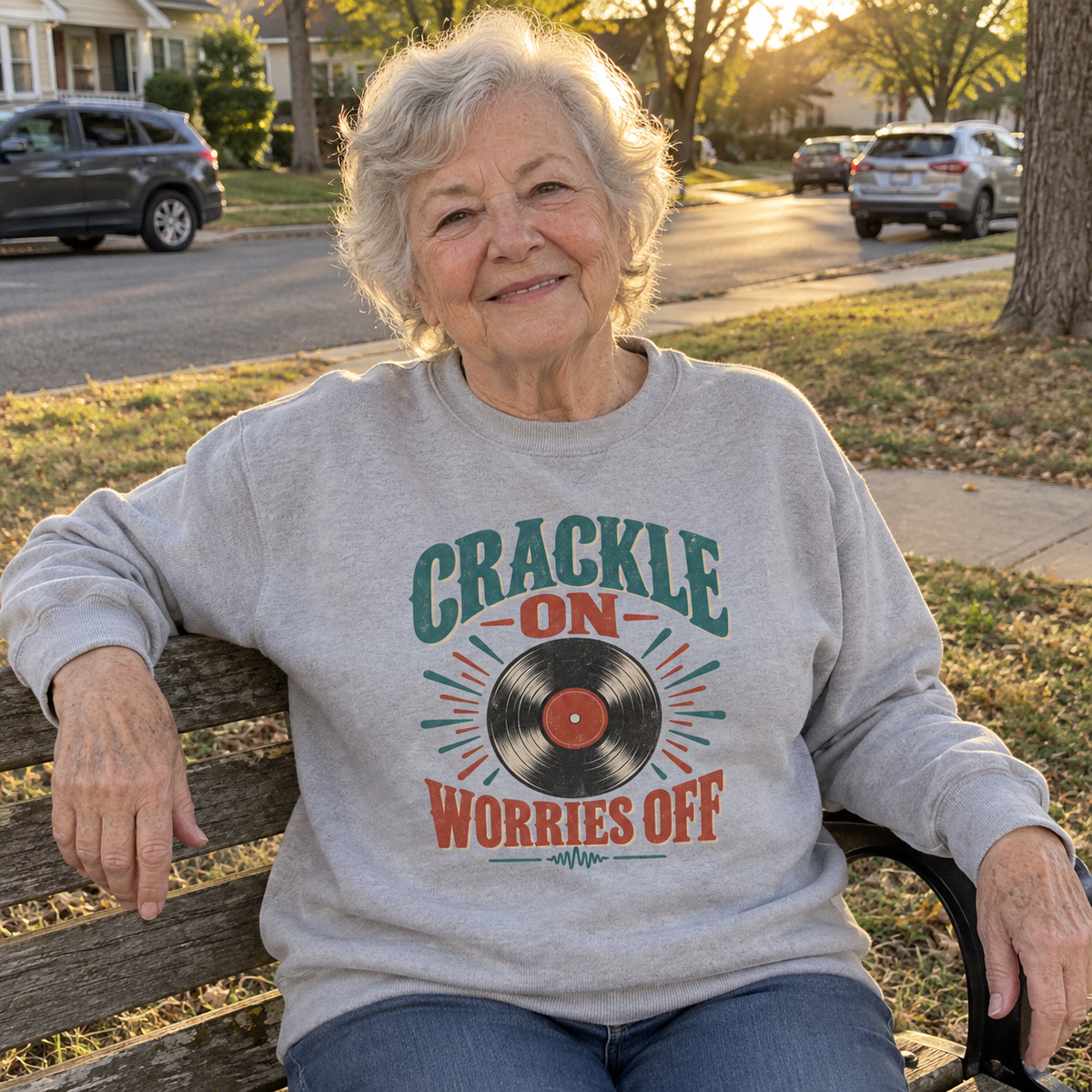 Senior woman wears gray vintage sweatshirt with printed Crackle On Worries Off record design
