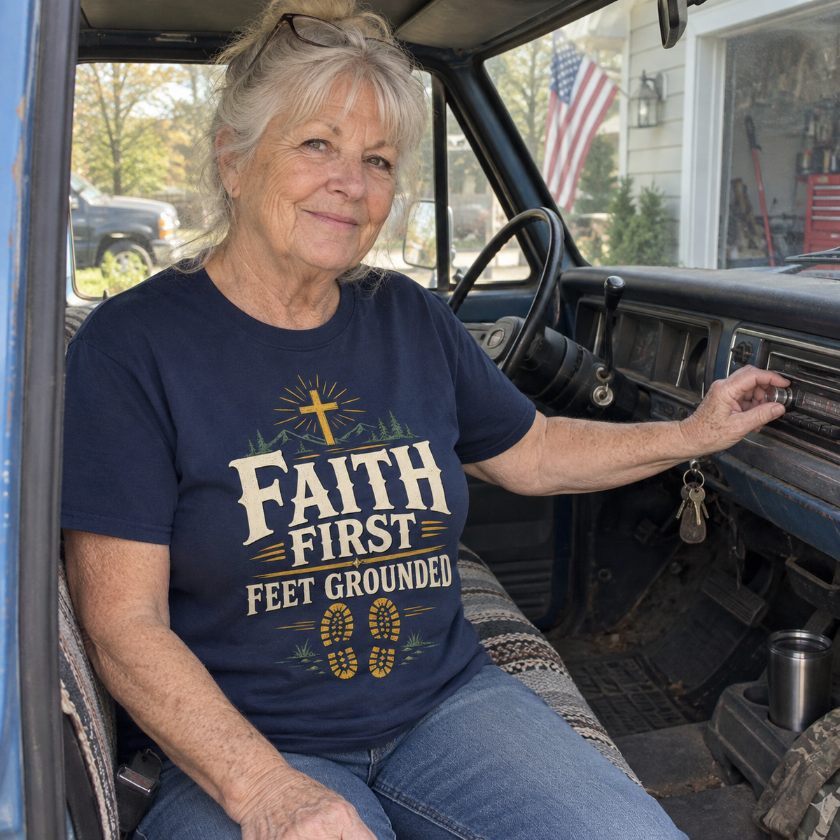 Senior woman in truck wears navy vintage t-shirt with printed Faith First Feet Grounded design