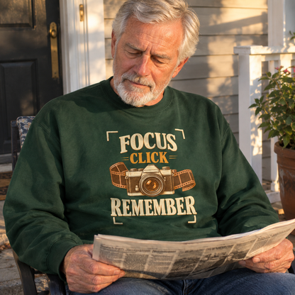 Senior man wearing dark green vintage sweatshirt with Focus Click Remember printed design, lifestyle setting