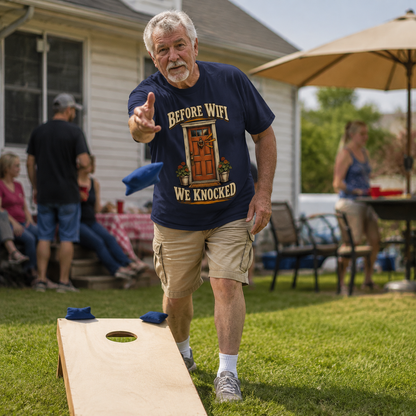 Senior man wearing navy vintage t-shirt with Before Wifi We Knocked print at backyard party.