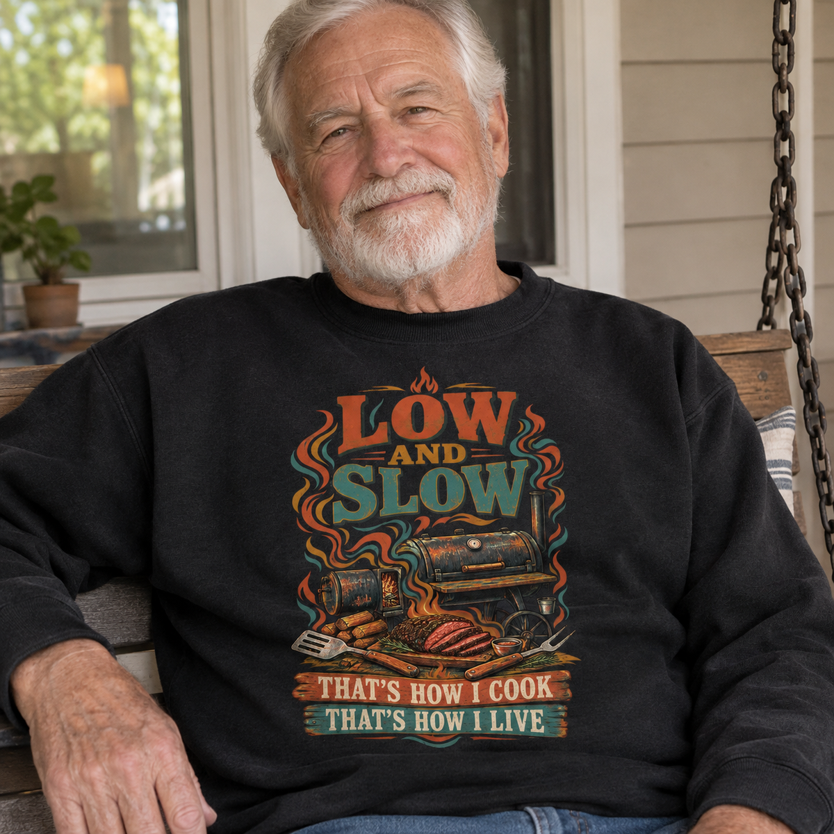 Senior man wearing black vintage sweatshirt with printed Low And Slow cooking design outdoors