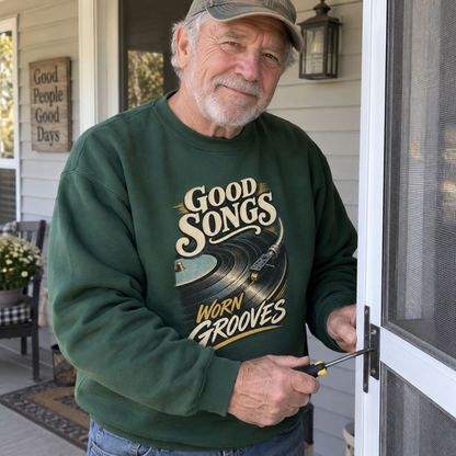 Green vintage sweatshirt with printed Good Songs Worn Grooves design, worn by senior man outdoors.