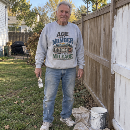 Senior man outdoors in gray vintage sweatshirt printed Age Is A Number Mine Has Mileage