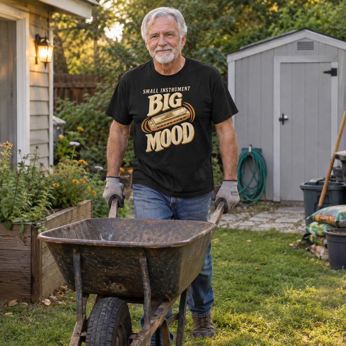 Senior man wearing black vintage t-shirt with printed Small Instrument Big Mood slogan, gardening outdoors