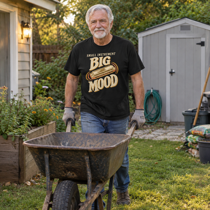 Senior man wearing black vintage t-shirt with printed Small Instrument Big Mood slogan, gardening outdoors