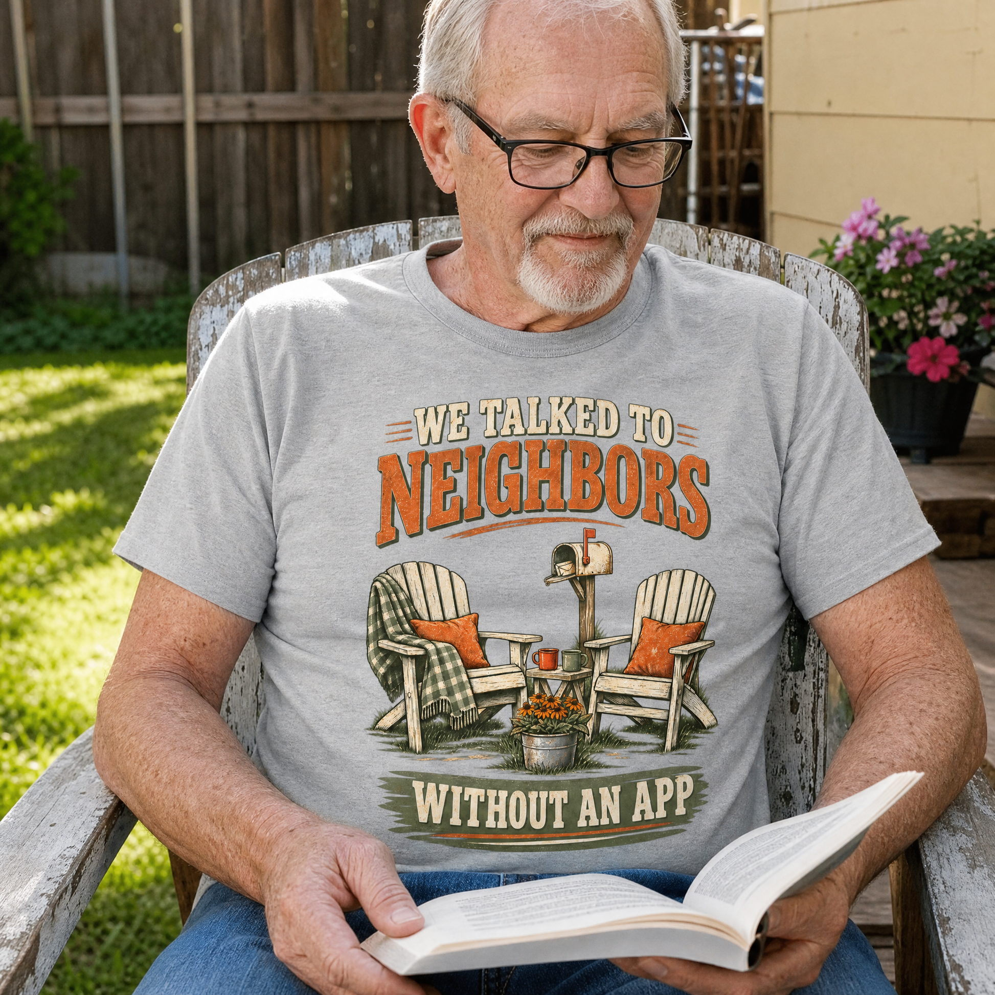 Gray vintage t-shirt with printed “We Talked To Neighbors Without An App” design worn by senior man reading outdoors.