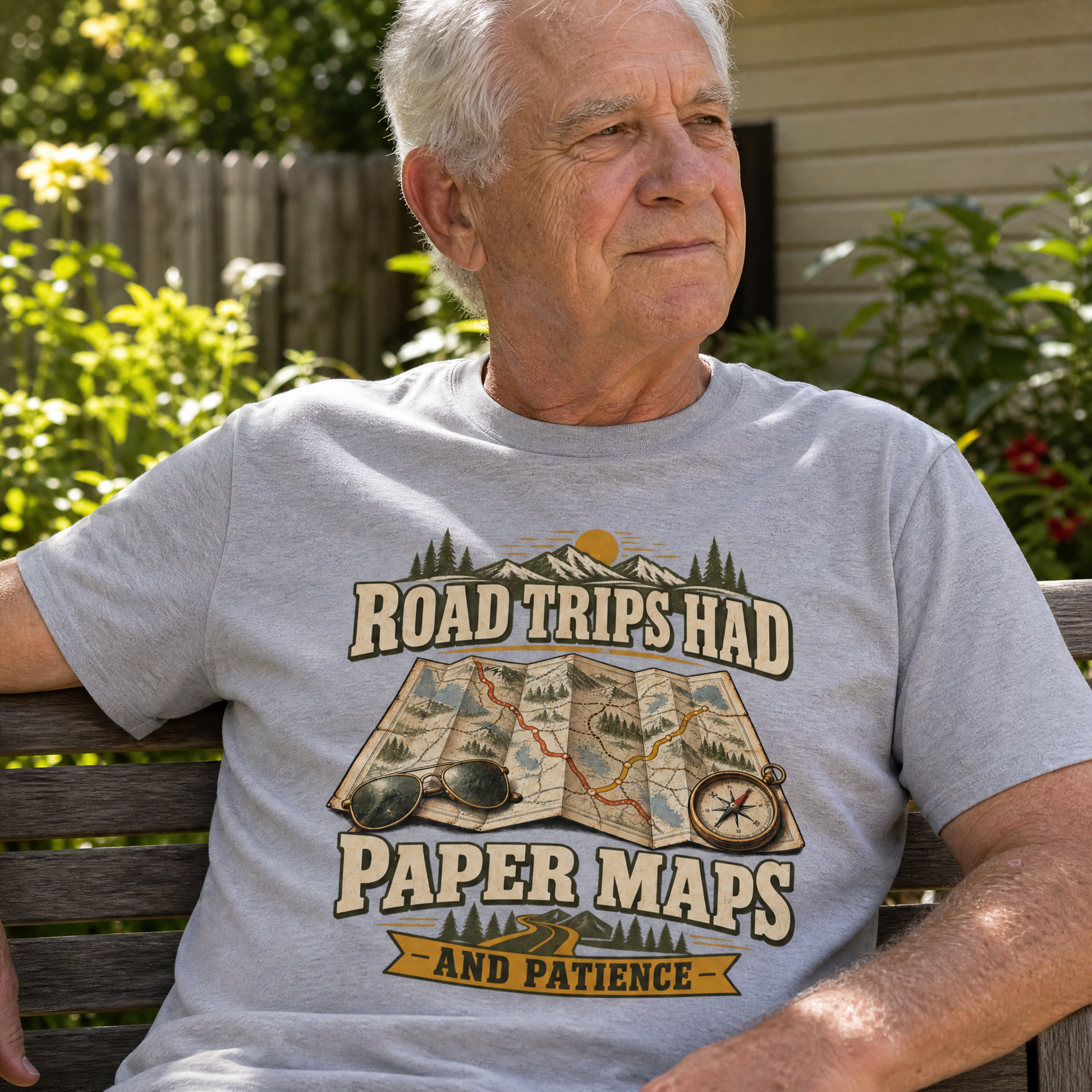 Gray vintage t-shirt with printed road trip map slogan worn by senior man outdoors.