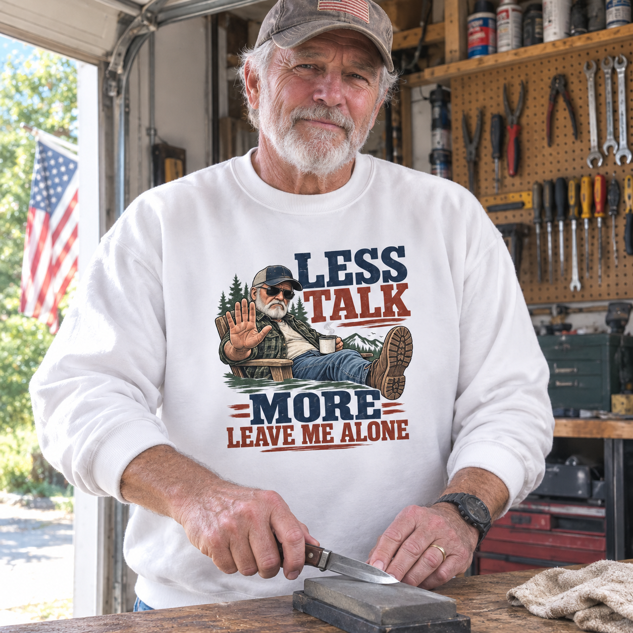 Senior man wearing white vintage sweatshirt with printed Less Talk More Leave Me Alone garage