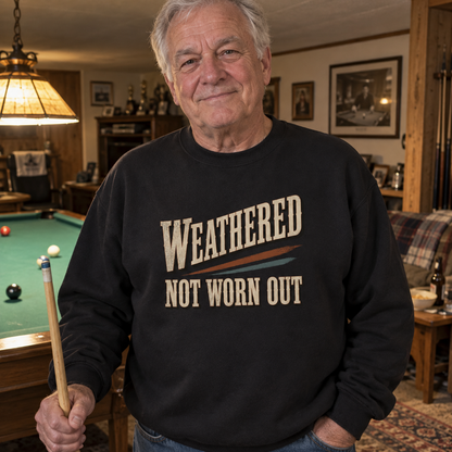 Senior man wearing black vintage sweatshirt with printed Weathered Not Worn Out by pool table