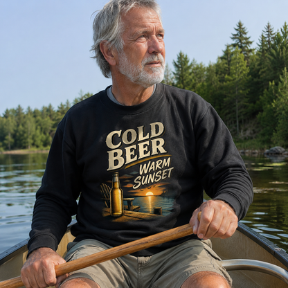 Senior man wearing black vintage sweatshirt with Cold Beer Warm Sunset print by lake