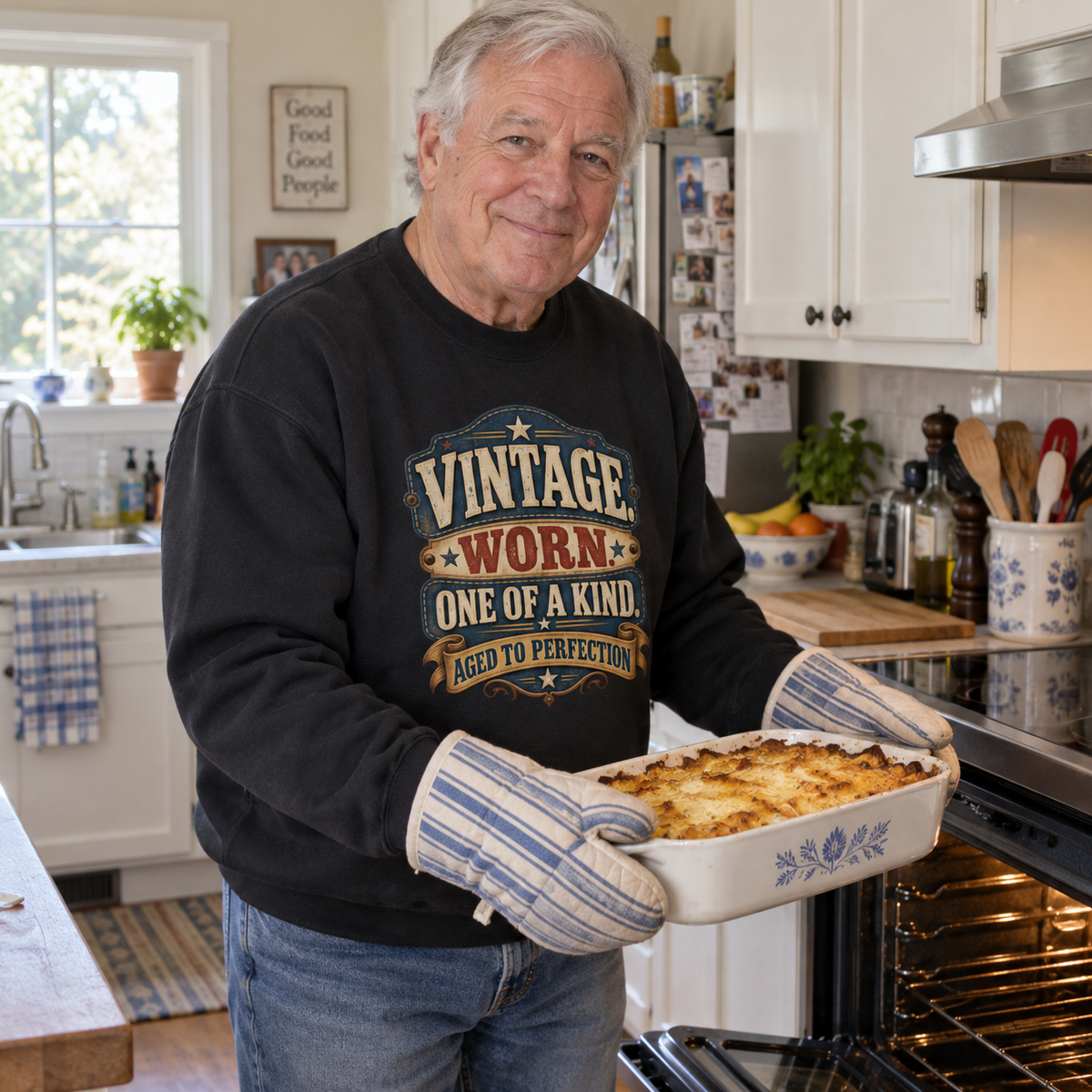 Senior man in kitchen wearing black vintage sweatshirt printed Vintage Worn One of a Kind.