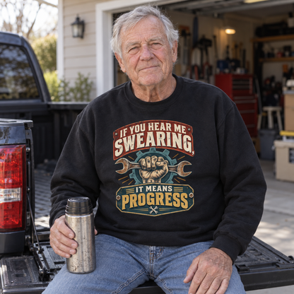 Senior man on pickup tailgate wears black vintage sweatshirt with printed swearing slogan.