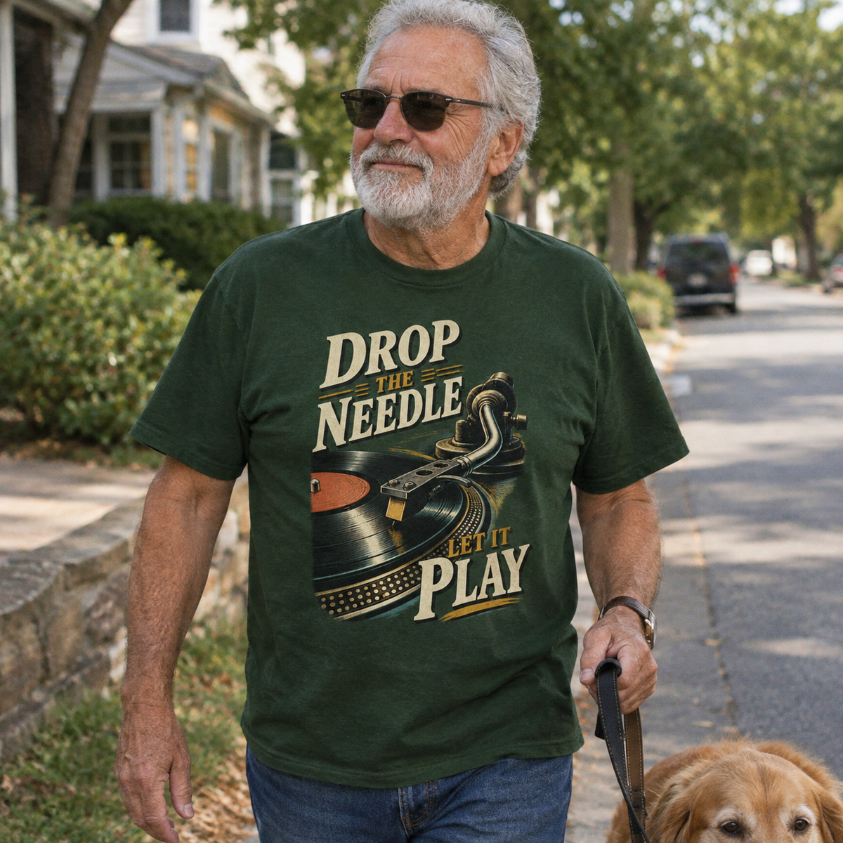 Senior man wearing dark green vintage t-shirt with printed Drop The Needle record design outdoors.