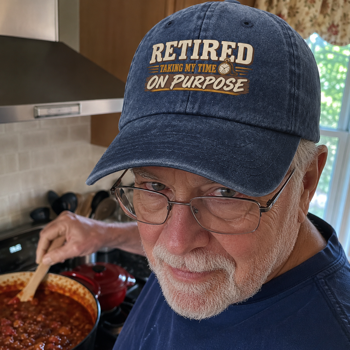 Senior man wearing blue vintage washed cap with printed Retired slogan in kitchen