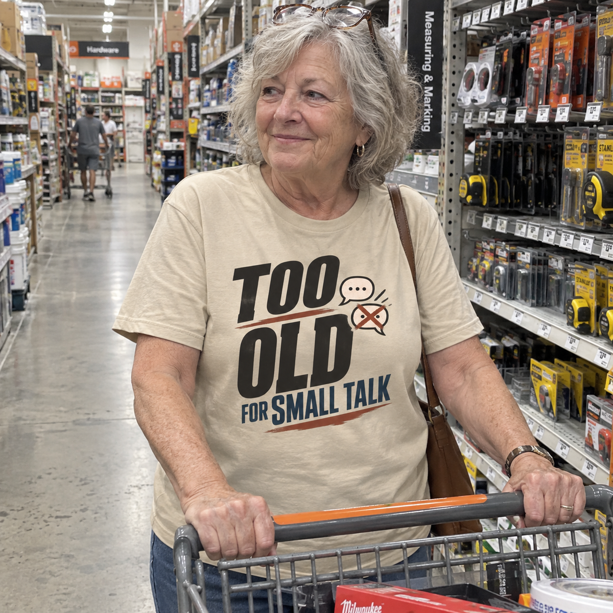 Senior woman wearing beige vintage t-shirt printed Too Old For Small Talk in hardware store