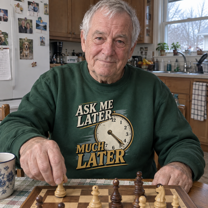 Senior man playing chess in green vintage sweatshirt with printed clock and slogan.