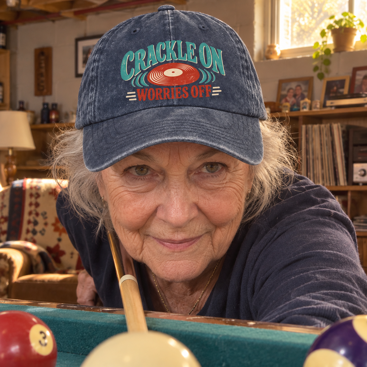 Senior woman playing pool in navy vintage washed cap printed Crackle On Worries Off