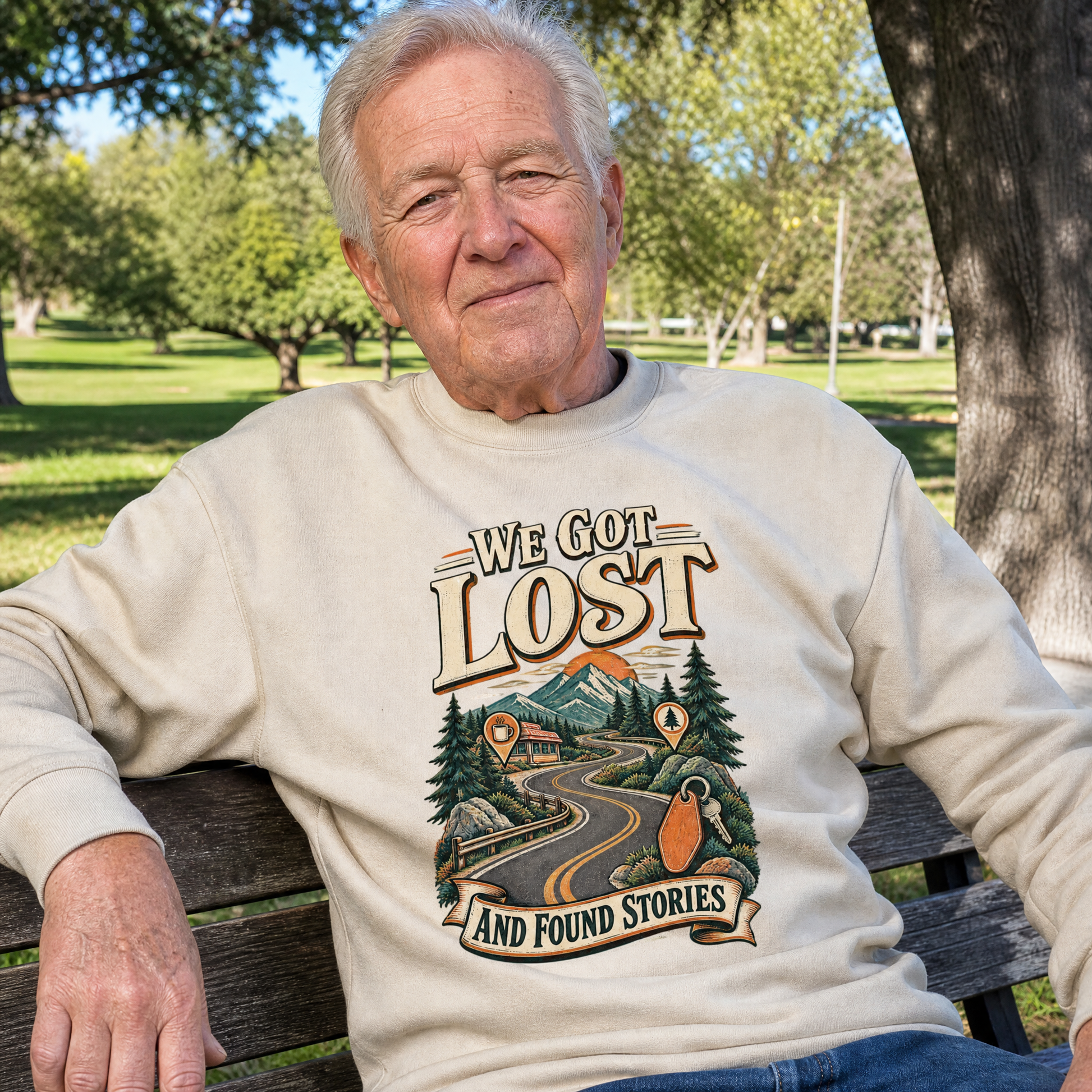 Senior man wearing cream vintage sweatshirt with printed We Got Lost And Found Stories