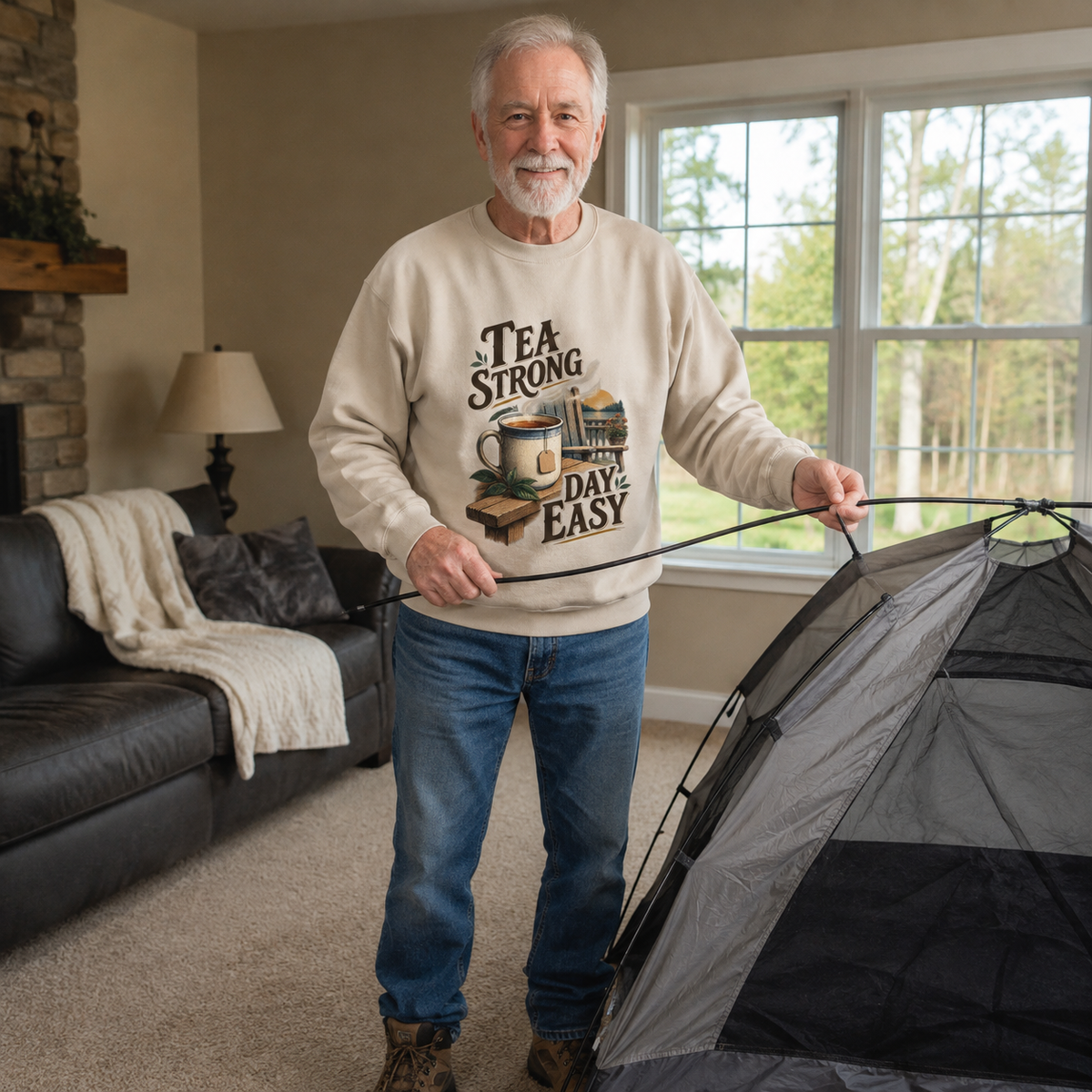 Senior man wearing beige vintage sweatshirt with printed Tea Strong Day Easy design indoors
