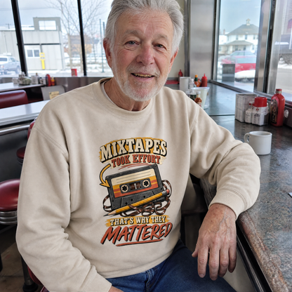 Senior man wearing cream vintage sweatshirt with printed cassette and mixtapes slogan