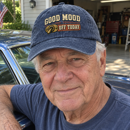 Senior man wearing navy vintage washed cap with printed Good Mood Off Today beside car