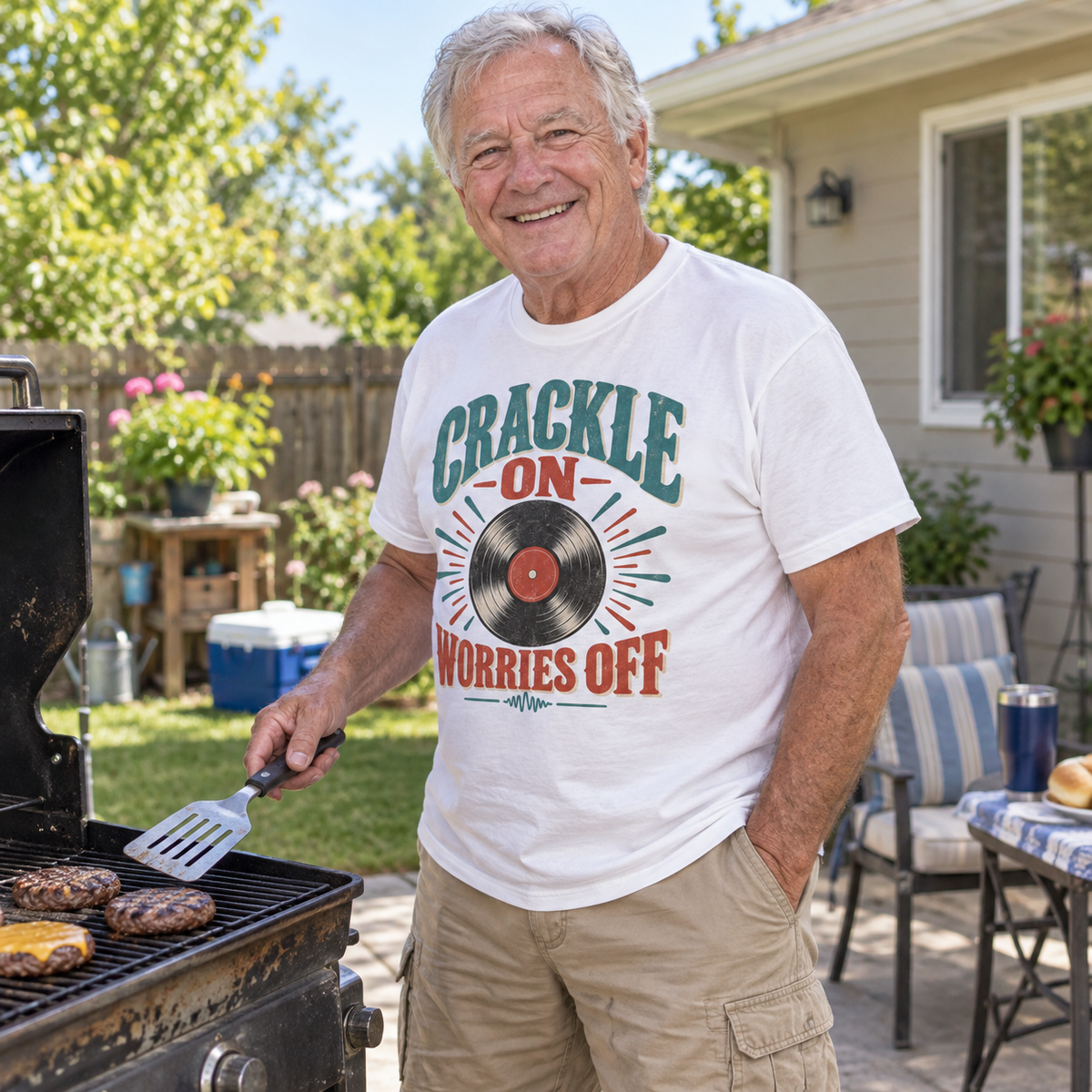Senior man grilling outdoors in white vintage t-shirt with printed Crackle On Worries Off design