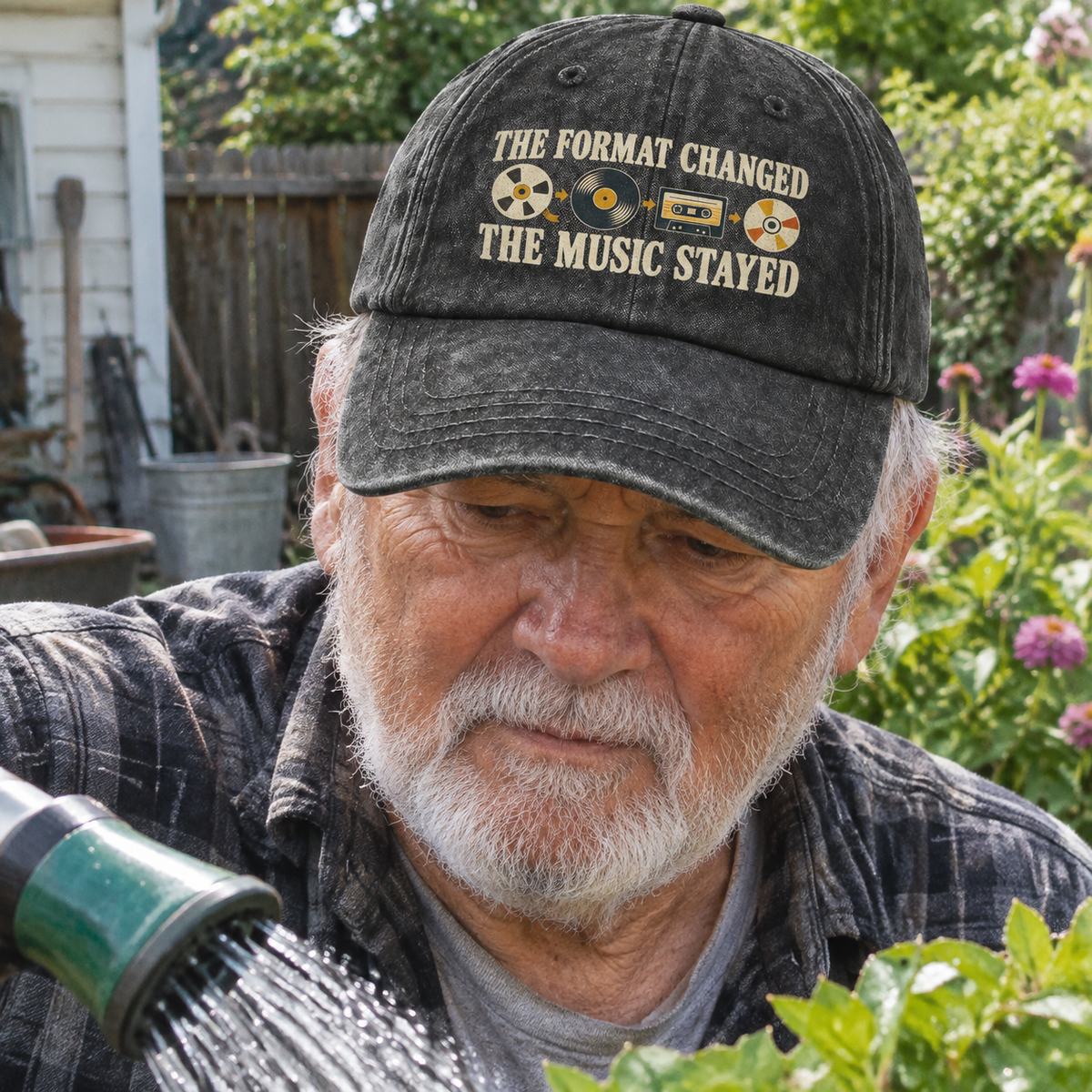 Senior man wearing black vintage washed cap with printed The Format Changed slogan outdoors