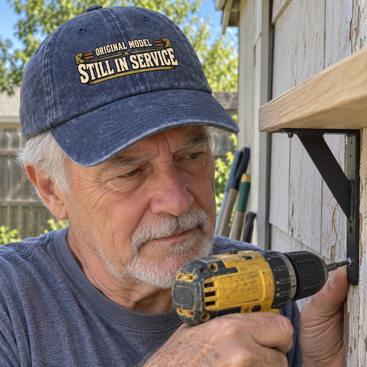 Senior man wearing navy vintage washed cap printed Original Model Still In Service while drilling