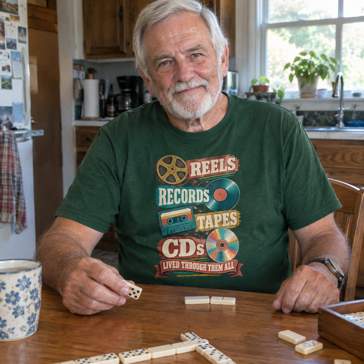 Senior man wearing green vintage t-shirt with printed Reels Records Tapes CDs design at table