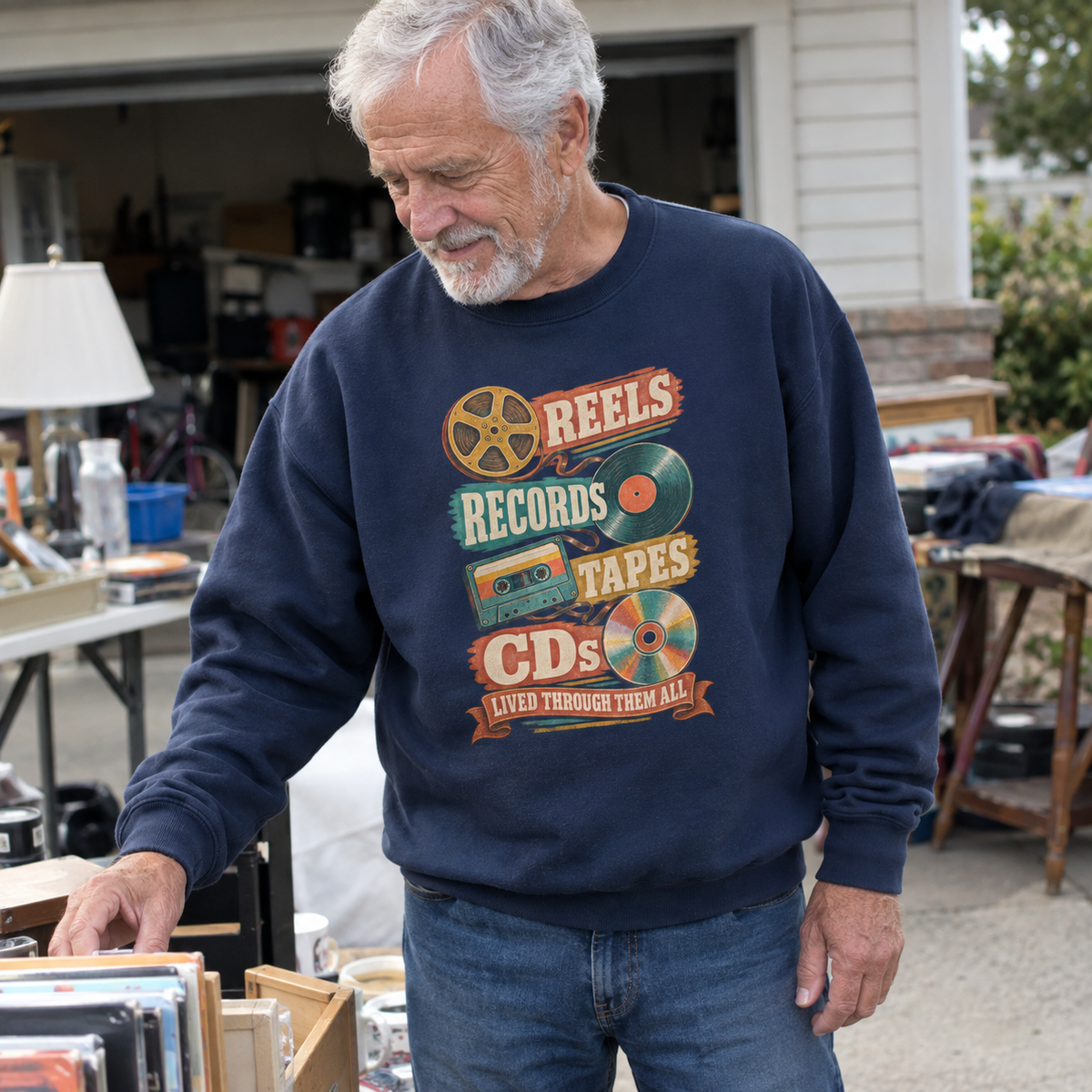 Senior man wearing navy vintage sweatshirt with printed reels records tapes CDs design outdoors

Refine the vintage music