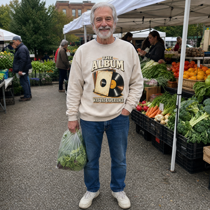 Senior man wearing a cream vintage sweatshirt with The Album Was The Experience print at market.