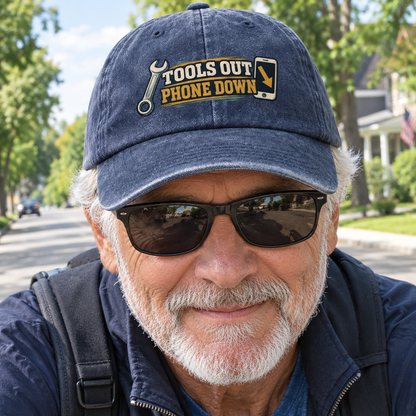 Senior man wearing navy vintage washed cap with printed Tools Out. Phone Down slogan