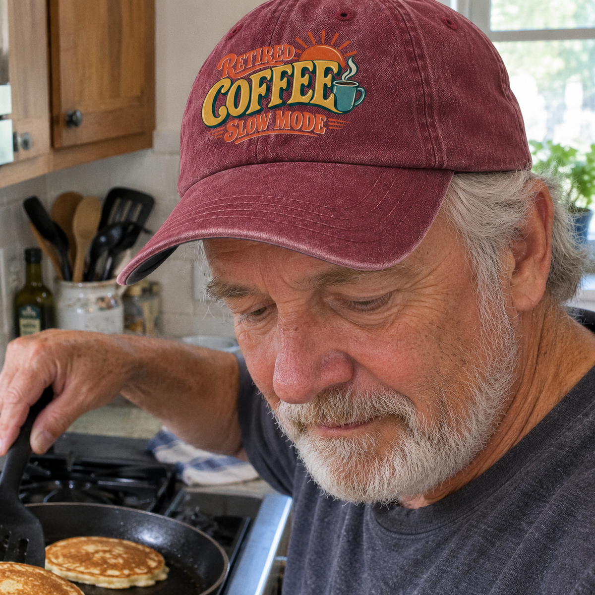Senior wearing vintage washed cap with Retired Coffee Slow Mode printed design